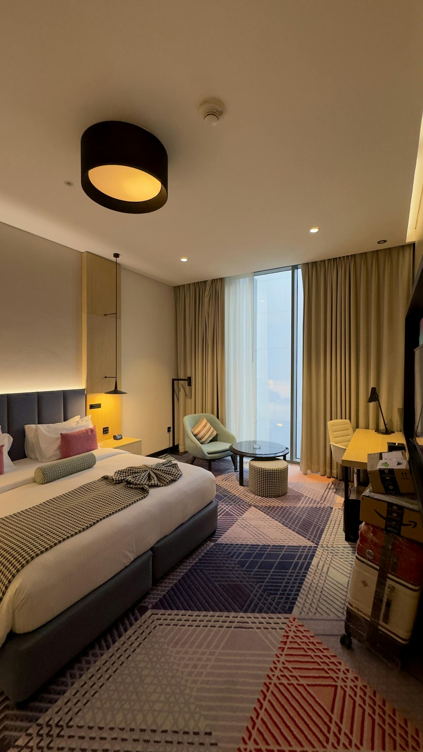 Elegant and spacious hotel room in Dubai with modern decor and designer furniture.